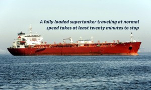 Horizontal image of a red Ultra Large Crude Carrier, or "Super Tanker."  These vessels are capable of carrying up to two million barrels of oil across the seas.